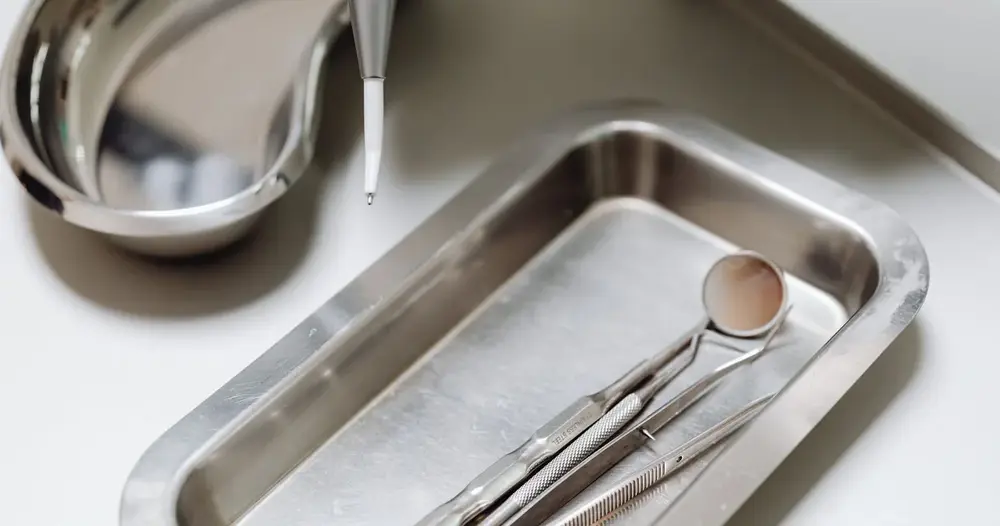 Instrumentos odontológicos esterilizados em bandeja de aço, material usado em clínicas de extração de siso em Taguatinga